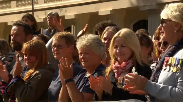 Clapping members of the crowd