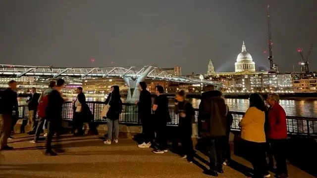 People queue in London on Wednesday night to see the Queen's coffin near the Millennium Bridge