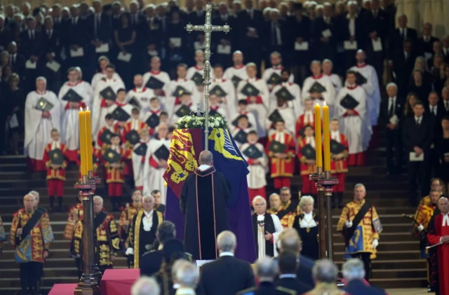 Queen Elizabeth II's draped in the Royal Standard rests on the catafalque at Westminster Hall