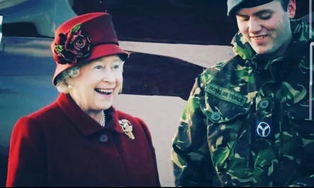 The Queen smiling after being taught how to set off an explosion by the RAF