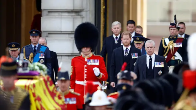 Prince Harry and Prince Andrew in procession, wearing suits not military uniforms