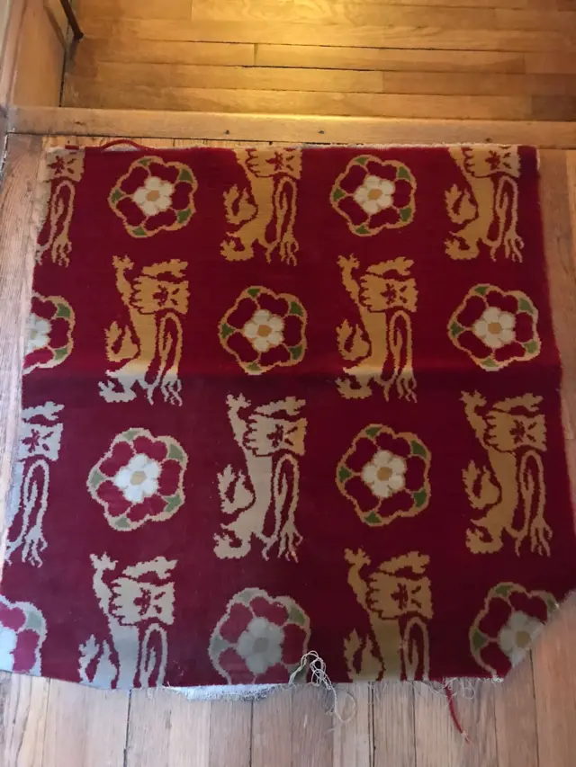 A section of carpet fitted underneath under the throne