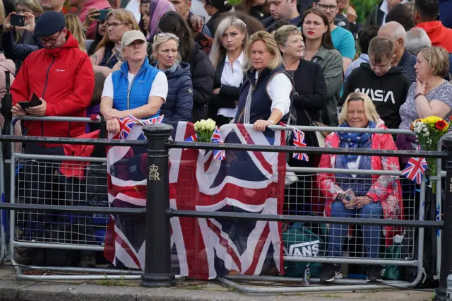 People behind a barrier