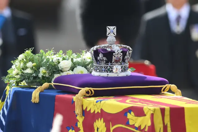 The Queen's crown on a purple cushion on the coffin