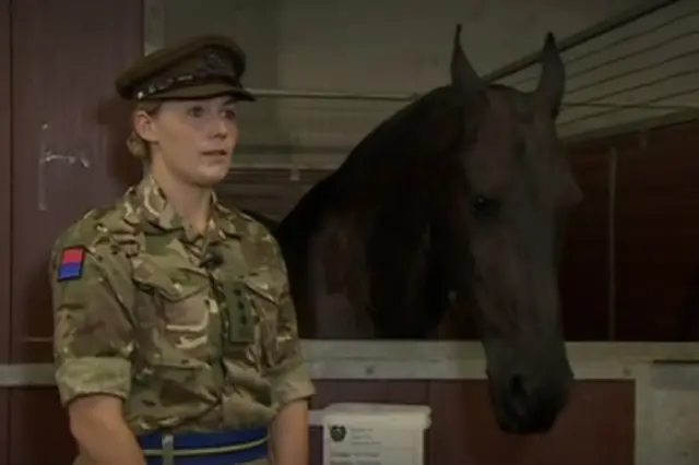 Captain Amy Cooper is filmed by the BBC alongside a horse named Windsor