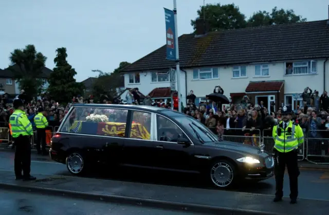 Thousands line the street to watch the Queen's hearse pass on its way to Buckingham Palace