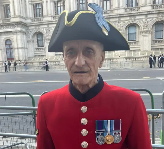 Chelsea pensioner Jack, in red unifirm wearing three medals