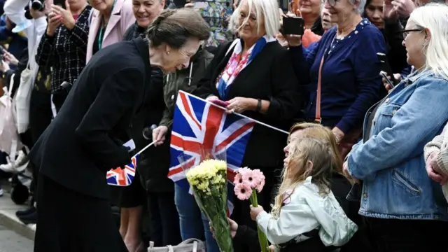 Princess Anne chatted with well-wishers and accepted flowers from a young girl