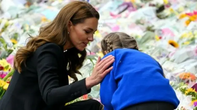 The Princess of Wales speaks with a King's Lynn pupil who lays down a tribute to Queen Elizabeth II