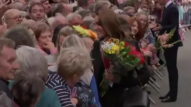 Catherine, Princess of Wales, receiving a bouquet of flowers