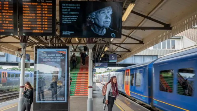 The Queen's face is seen on a train information board at Clapham Junction station, south-west London