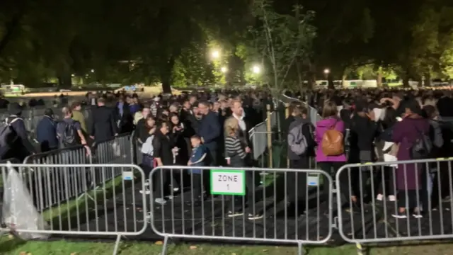 As day turns to night, people are still joining the queue to see the Queen's coffin