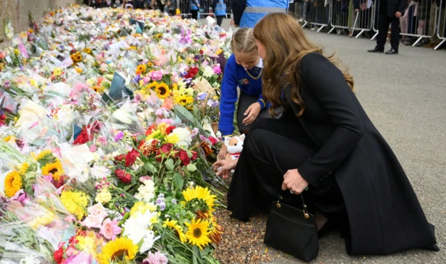 The Princess of Wales views floral tributes left by members of the public at the gates of Sandringham House in Norfolk