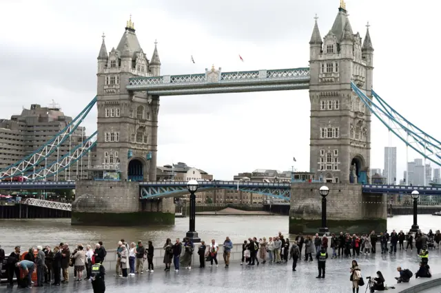 Members of the public in the queue near to Tower Bridge