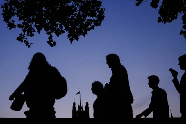 People queue to pay their respects to Queen Elizabeth II as she lies in state in Westminster Hall, London