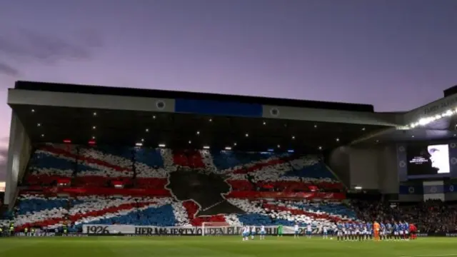 Rangers fans at Ibrox Stadium hold up colours to form an image of the Union Jack on Wednesday