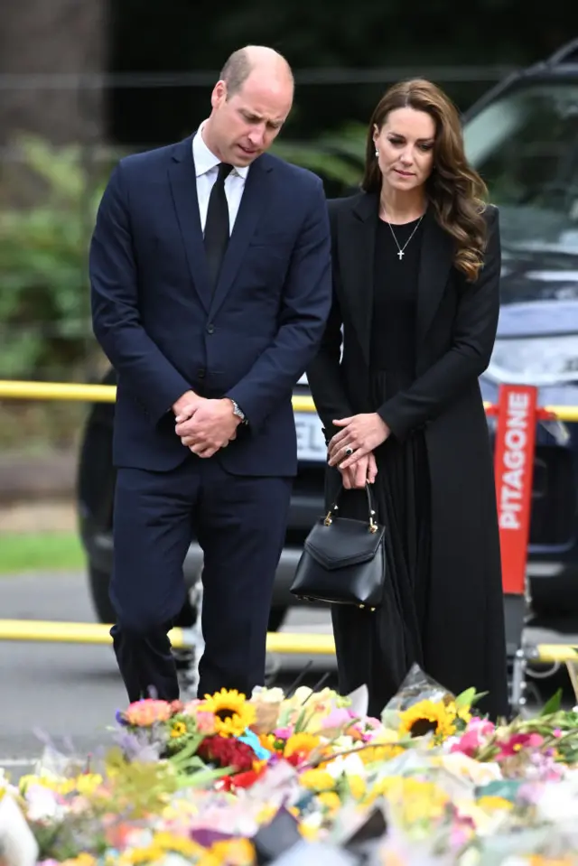 Prince William and Catherine viewing floral tributes in Sandringham