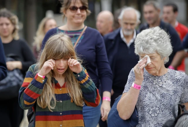 Amy Stitt and her mother Charlotte Baker wipe tears from their eyes