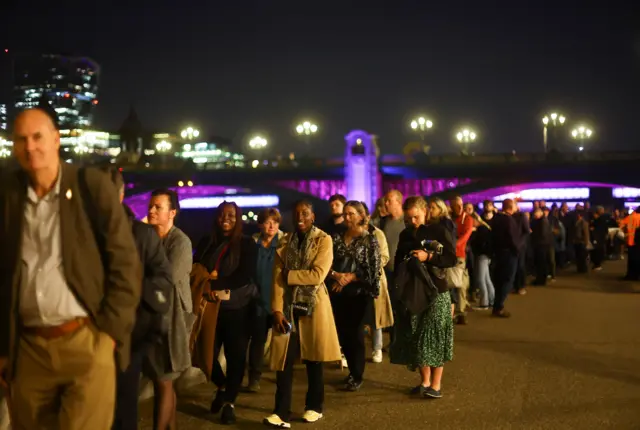 People queue through the night to see the Queen's coffin