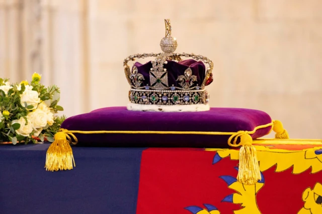 The coffin has been draped in a Royal Standard and the Imperial State Crown placed on top