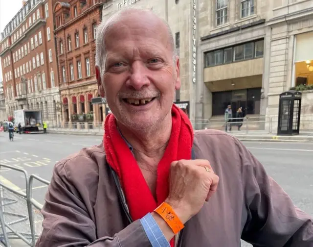 Garry High from Guildford shows off his wristband after going to see the Queen's lying in state