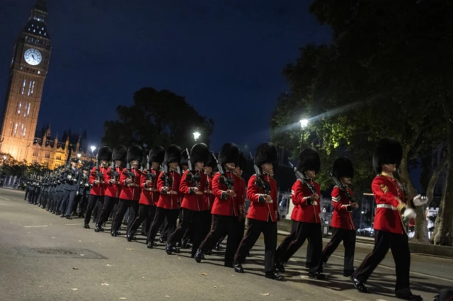 Grenadier Guards marching by the Palace of Westminster