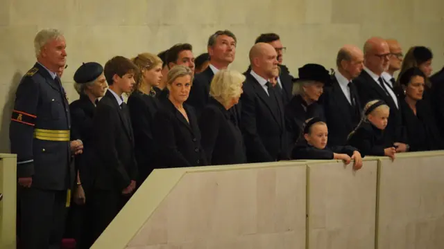 Members of the royal family including James, Viscount Severn, Lady Louise Windsor, the Countess of Wessex, Jack Brooksbank, the Queen Consort, Vice Admiral Sir Tim Laurence, Zara Tindall, Mike Tindall, the Duke of Kent, Mia and Lena Tindall, the Duchess of Gloucester, and the Earl and Countess of St Andrews attend the vigil by King Charles III, the Princess Royal, the Duke of York and the Earl of Wessex beside the coffin of their mother, Queen Elizabeth II