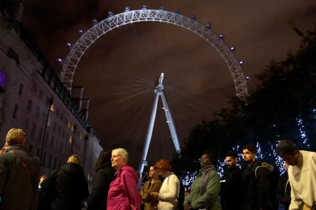 People standing in the queue on the South Bank in London adjacent to the London Eye on Thursday evening.