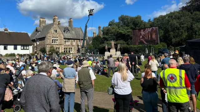 Crowds gather on Cathedral Green in Llandaff