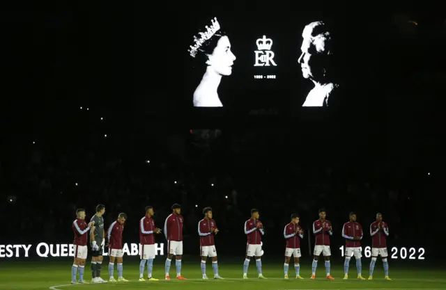 Aston Villa Players in a line, with the lights turned off in Villa Park stadium