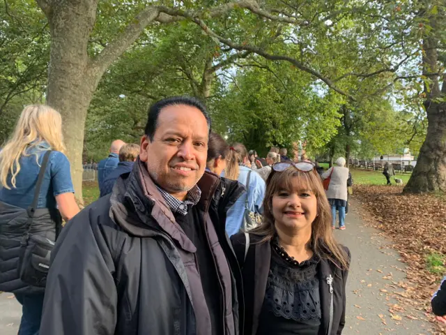 Picture shows Sanjay, left and Sardah, right, wearing dark clothing and smiling for the camera in Southwark Park