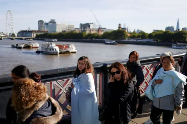 People wearing blankets after chilly overnight temperatures