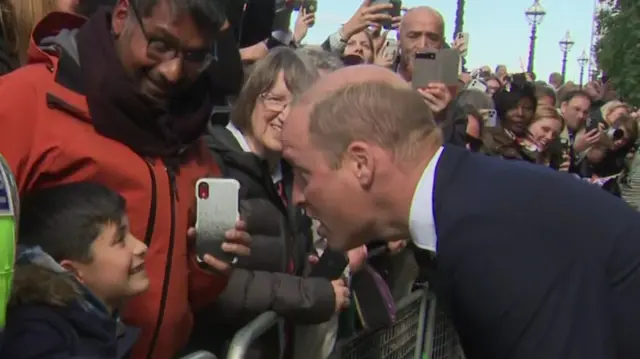 The Prince of Wales meets people in the queue