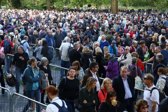 People winding their way along the queue in Southwark Park