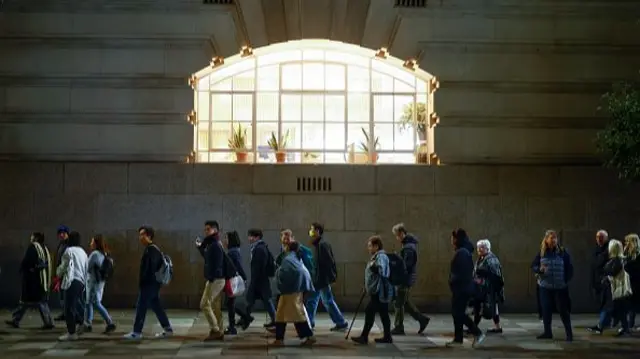 People seen standing in a queue in London