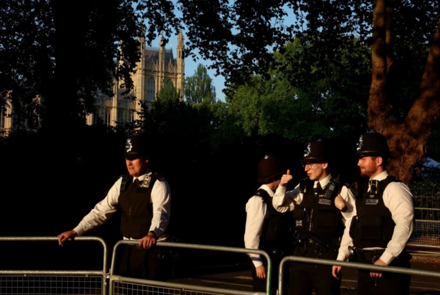 Police officers stand outside Westminster