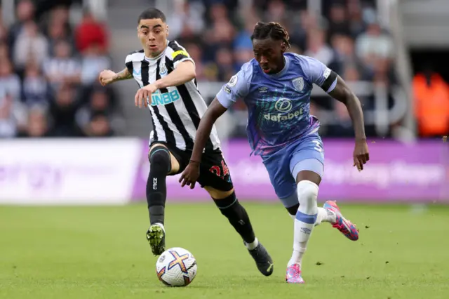 Jordan Zemura of AFC Bournemouth is challenged by Miguel Almiron