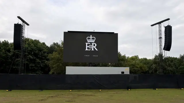 A giant screen, bearing the Queen's official ER logo, set up in Hyde Park