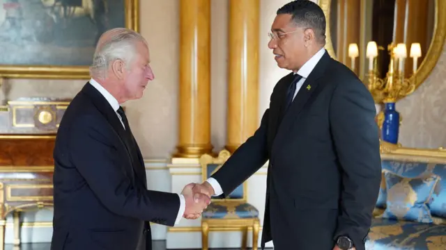 King Charles greets the Prime Minister of Jamaica, Andrew Holness, at Buckingham Palace