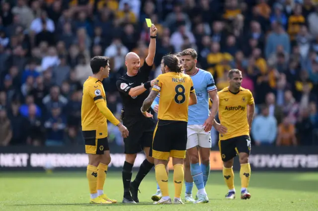 Ruben Neves of Wolverhampton Wanderers is shown a yellow card