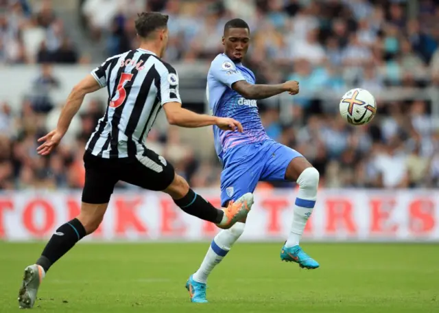 Jaidon Anthony knocks the ball past Fabian Schar