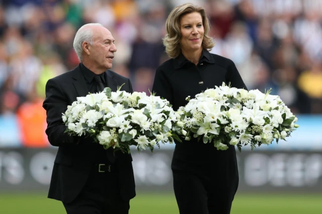 Bournemouth chairman Jeff Mostyn and Newcastle United part owner Amanda Staveley carry wreaths before the match