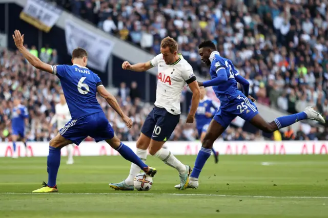 Harry Kane battles for possession with Jonny Evans and Wilfred Ndidi