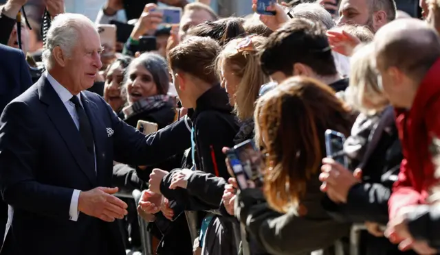 Britain's King Charles greets people, while they queue to pay their respects to Britain's Queen Elizabeth, following her death, in London, Britain, September 17, 2022.