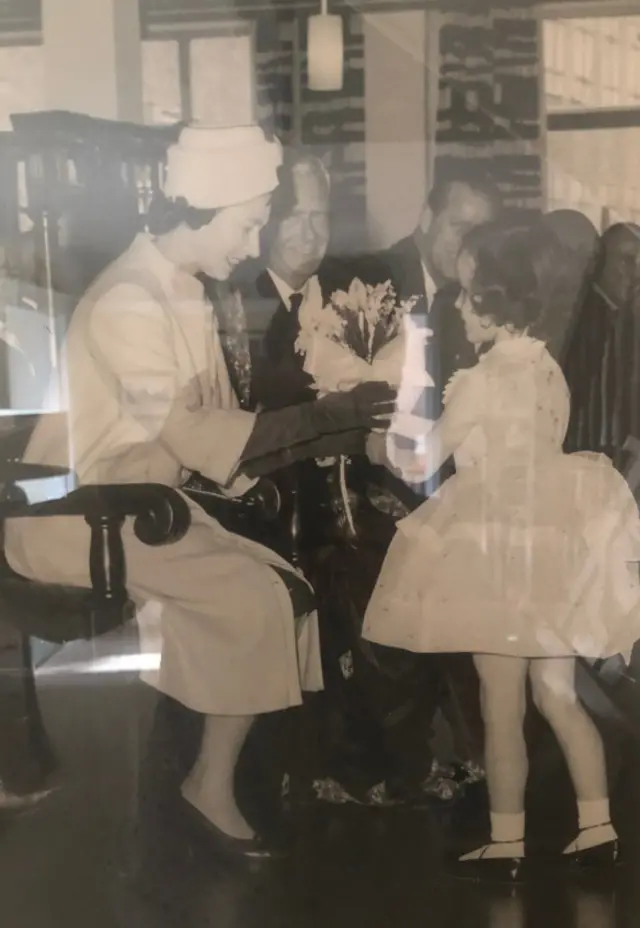 The Queen being presented with flowers