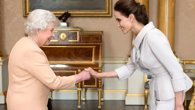 The late Queen Elizabeth II receives actress Angelina Jolie in the 1844 Room at Buckingham Palace in 2014