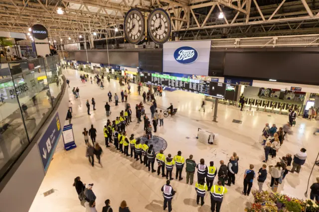 Members of the public hold a minute of silence in Queen Elizabeth II's honour at Waterloo Station on September 18, 2022 in London, United Kingdom