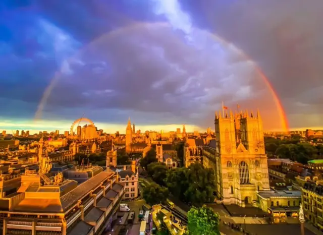 A rainbow is seen above Westminster Hall where the Queen's coffin currently is