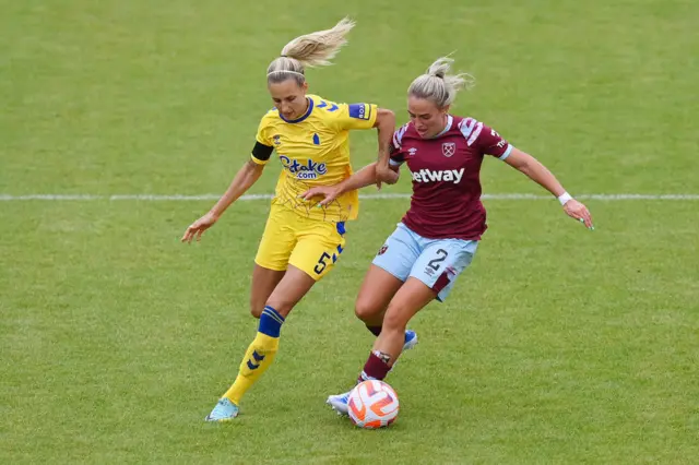 Nathalie Bjorn battles for possession with Kirsty Smith