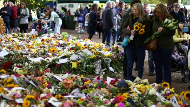 People view floral tributes in Green Park following the death of Britain's Queen Elizabeth, in London, Britain September 18, 2022.